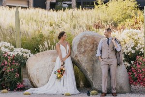 Newlyweds sharing a sweet and intimate moment on a pristine Cabo beach.