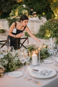 wedding planner is setting up the tables